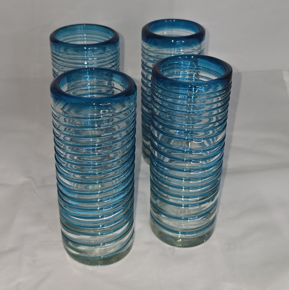 Set of 4 hand-blown Mexican drinking glasses with an aqua blue spiral design.
